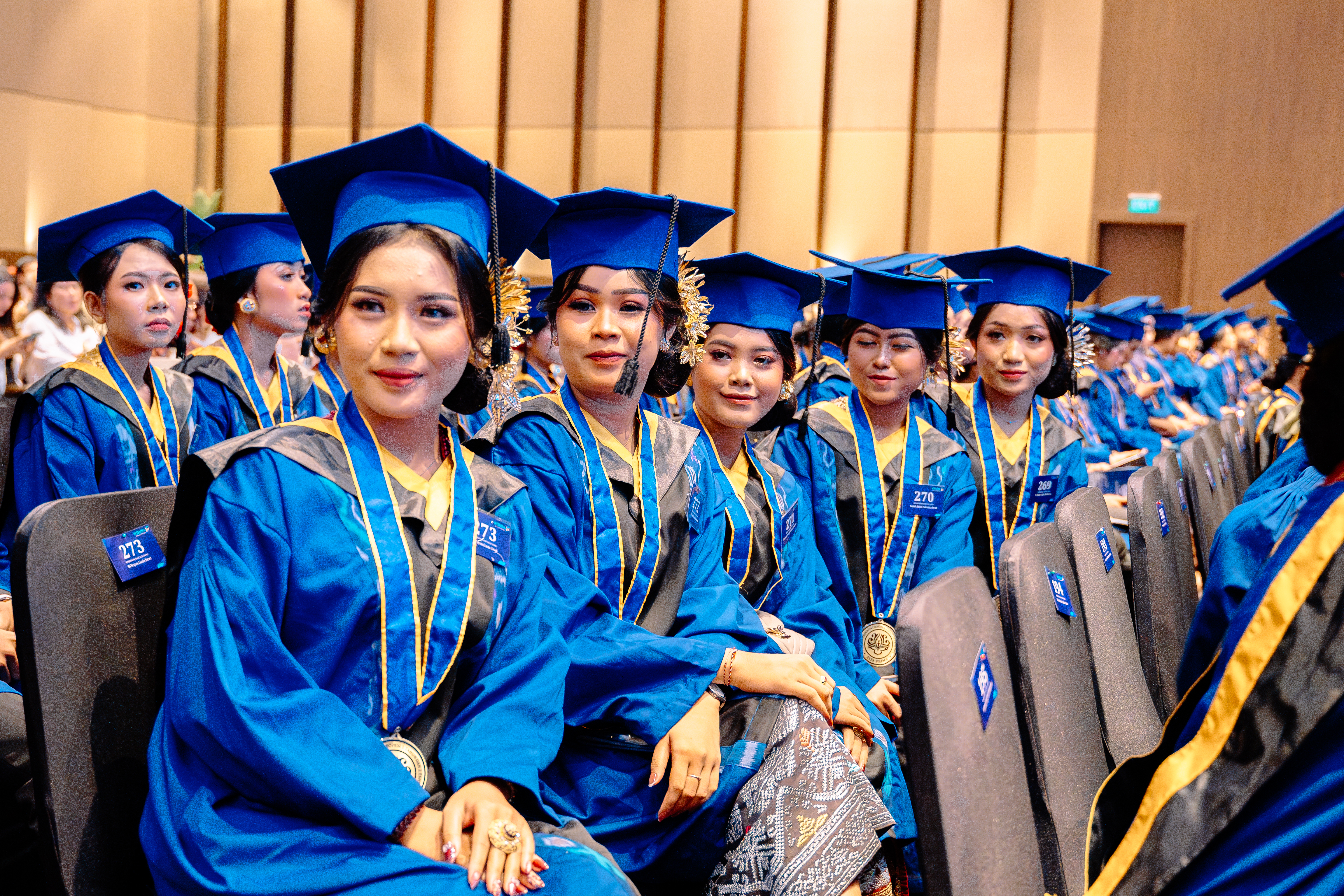 Happy graduates throwing caps